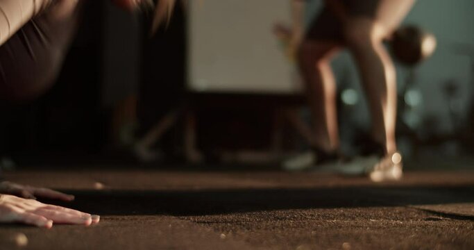 Unrecognizable man and woman exercising in gym