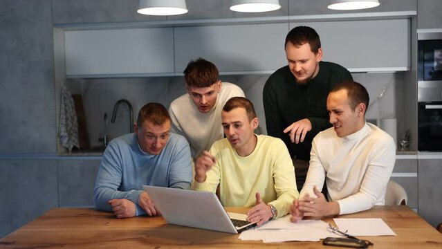 Group of friends watching funny comedy movie on laptop indoors