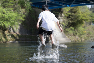 Back view of a boy (boys) playing in the river without face Leisure, outdoor, summer vacation, gw, and other long vacation travel images.