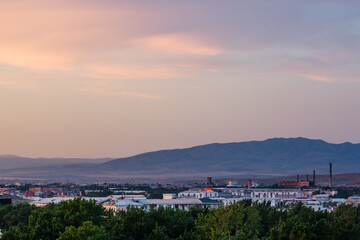 Sunset over the city with mountains