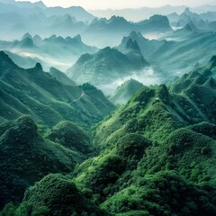 view of the green mountain ranges from above, in the style of mysterious backdrops, uhd image - obrazy, fototapety, plakaty