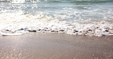 Crashing ocean waves on a sandy beach