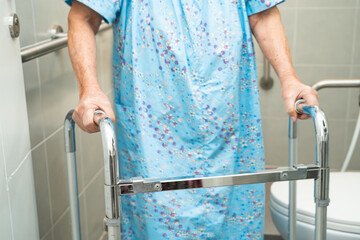 Asian elderly woman patient use toilet bathroom handle security in nursing hospital, healthy strong...