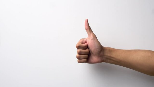 Man's hand with thumb up and down gesture on white background