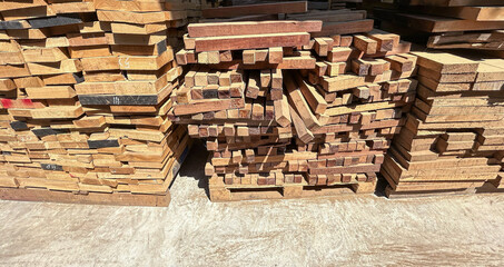 Lumber planks stack in the sawmill.  Stacked of woods on ground in furniture factory - 784956936