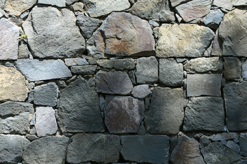 Stone wall texture background - grey stone with different sized stones