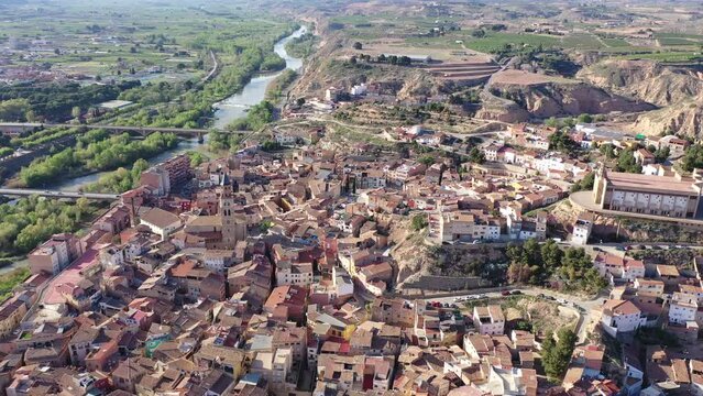 Scenic spring aerial view of El casco or Fraga la Vieja, old historic district of Spanish town of Fraga located on hilly Cinca river valley on sunny day. High quality 4k footage