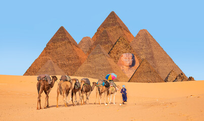 A woman tourist riding a camel with a multicolored umbrella - Abstract background many pyramid in Giza - Cairo, Egypt