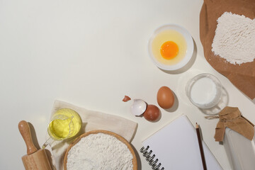 Copy space photo with many essential baking cake ingredients flat lay on white kitchen counter top, available photo whether you advertising bread, brownies, cookies, cakes or tarts. 