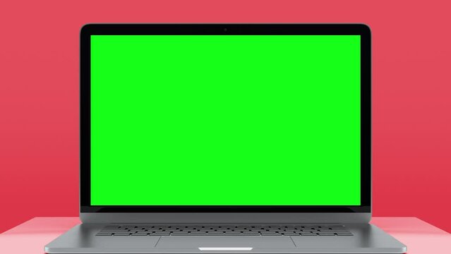 Laptop Computer with Green Screen for Chroma Key. Zoom In on Mock Up of Working PC with Greenscreen for Chromakey on Red Color Background. Presentation of New Electronic Object with Horizontal View
