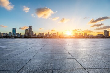 City square floor and Shanghai Bund skyline with modern buildings at sunset - obrazy, fototapety, plakaty