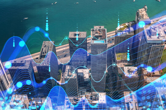 Aerial view of a city with a digital hologram overlay, depicting futuristic technology on skyscrapers, blue tones dominate. Double exposure - Powered by Adobe