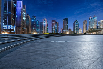 City square floor and modern commercial building scenery at night in Shanghai. Famous financial district buildings in Shanghai.