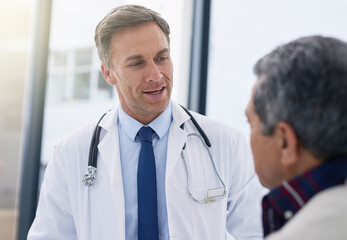 Hospital, consulting and doctor with patient for medical service, help and talking for diagnosis results. Healthcare, clinic and physician with man for prescription, medication and wellness treatment