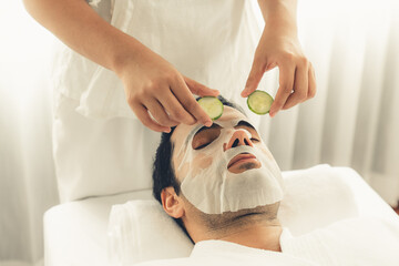 Serene daylight ambiance of spa salon, man customer indulges in rejuvenating with luxurious...