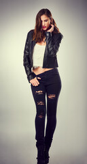 Woman, thinking and party outfit with fashion, rock style and clothes in studio with punk jeans. Grunge, leather and modern style with cool, trendy and edgy rocker clothing in white background