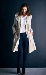 Fashion, happy and business woman on wall background with trendy clothes, stylish coat and outfit. Office, professional style and person with confidence, pride and smile for career, working and job