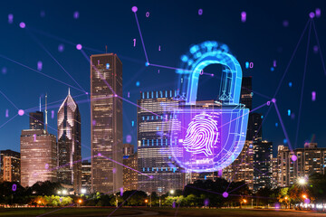 Chicago cityscape at night with a digital hologram of a lock and fingerprint, representing security...