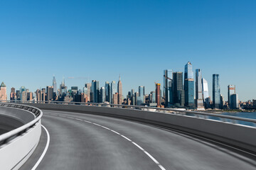 Fototapeta premium Empty urban asphalt road exterior with city buildings background. New modern highway concrete construction. Concept of way to success. Transportation logistic industry fast delivery. New York. USA.