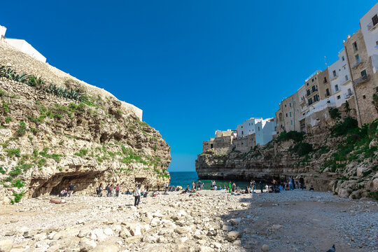 Polignano a Mare, beautiful city with a beach between the city cliffs. Colorful picture of a picturesque village in italian puglia on a sunny spring day.