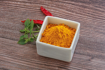 Yellow vibrant curcuma powder in the bowl