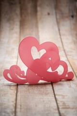 Pink heart on the wooden background