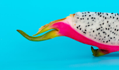 Dragon fruit in a section isolated on a blue background
