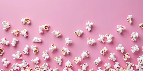 Poster Playful top view of white popcorn scattered on a bright pink background, concept of leisure snacks. © tashechka