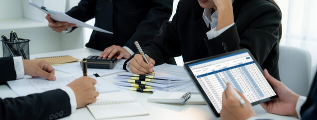 Corporate accountant team use accounting software on tablet to calculate and maximize tax refunds...