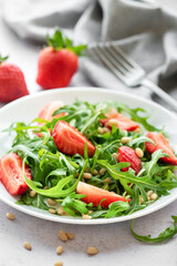 Fresh Strawberry Arugula Salad With Pine Nuts Served on a Bright Day