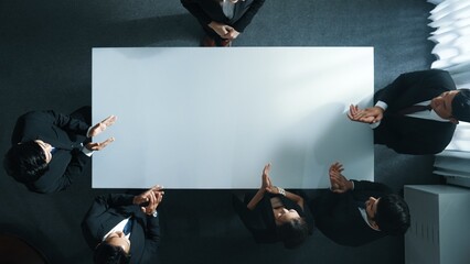 Top down aerial view of skilled business team clapping hands to celebrate young businesswoman...