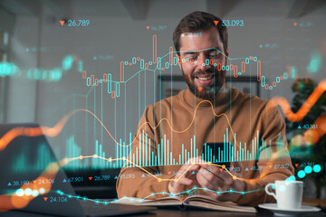 Handsome businessman working on laptop at office workplace in background. Using phone to read text, and send messages. Concept of forex and stock market trading. charts hologram