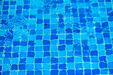 drops of water on the surface of the water in the pool