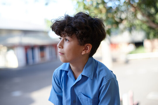 Young school boy thinking looking afar