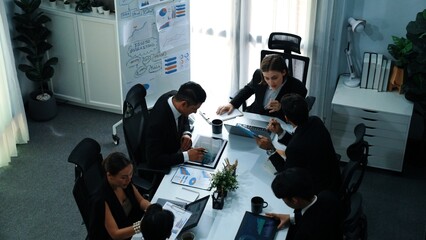 Top view of smart businesspeople working together at meeting. Manager looking at financial document...