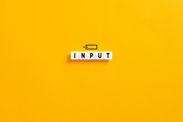 White letter blocks on yellow background with the word input. Business or technology concept.