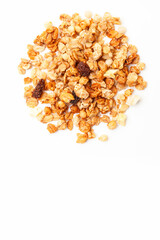 Pile of Muesli oat cereals with raisins, dried fruits and sunflower seeds on white background. Top...