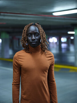 South Sudanese man standing in a carpark