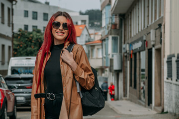 Obraz premium young tourist woman with backpack and leather jacket on the street