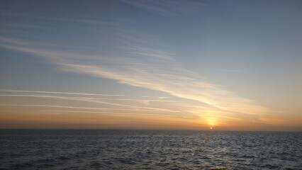 Naklejka na ściany i meble Sun rising above Red sea at spring. Seascape with the horizon of the sea.