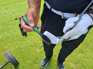 Man Holding Golf Club Putting It in Bag