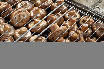 Mushrooms grilling on gas cooker, tasty finger food cooking