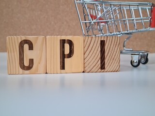 CPI, consumer price index concept. Wooden block with the words CPI on coins stack