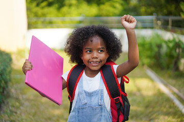 Back-to-school season with african american kid girl on the move with book and colorful school...