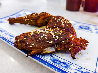 Grilled chicken with spicy sauce served in Chinese style with sesame seed.