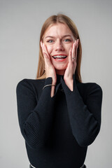 Smiling Woman in Black Top against gray background