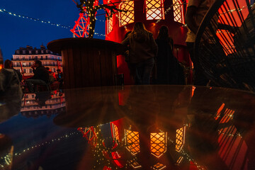 Moulin Rouge at night with lights during French sunset. Spinning moulin in red color lights during...
