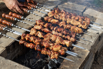Food being grilled on skewers, creating a delicious Souvla recipe over charcoal