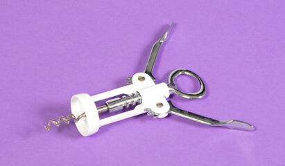 Old bottle opener isolated on solid purple background - 785040170