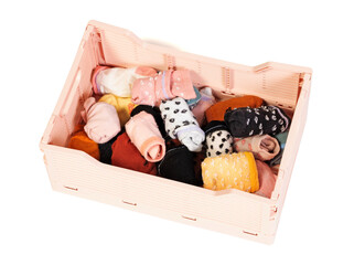 Colorful baby socks in a small crate isolated on white background